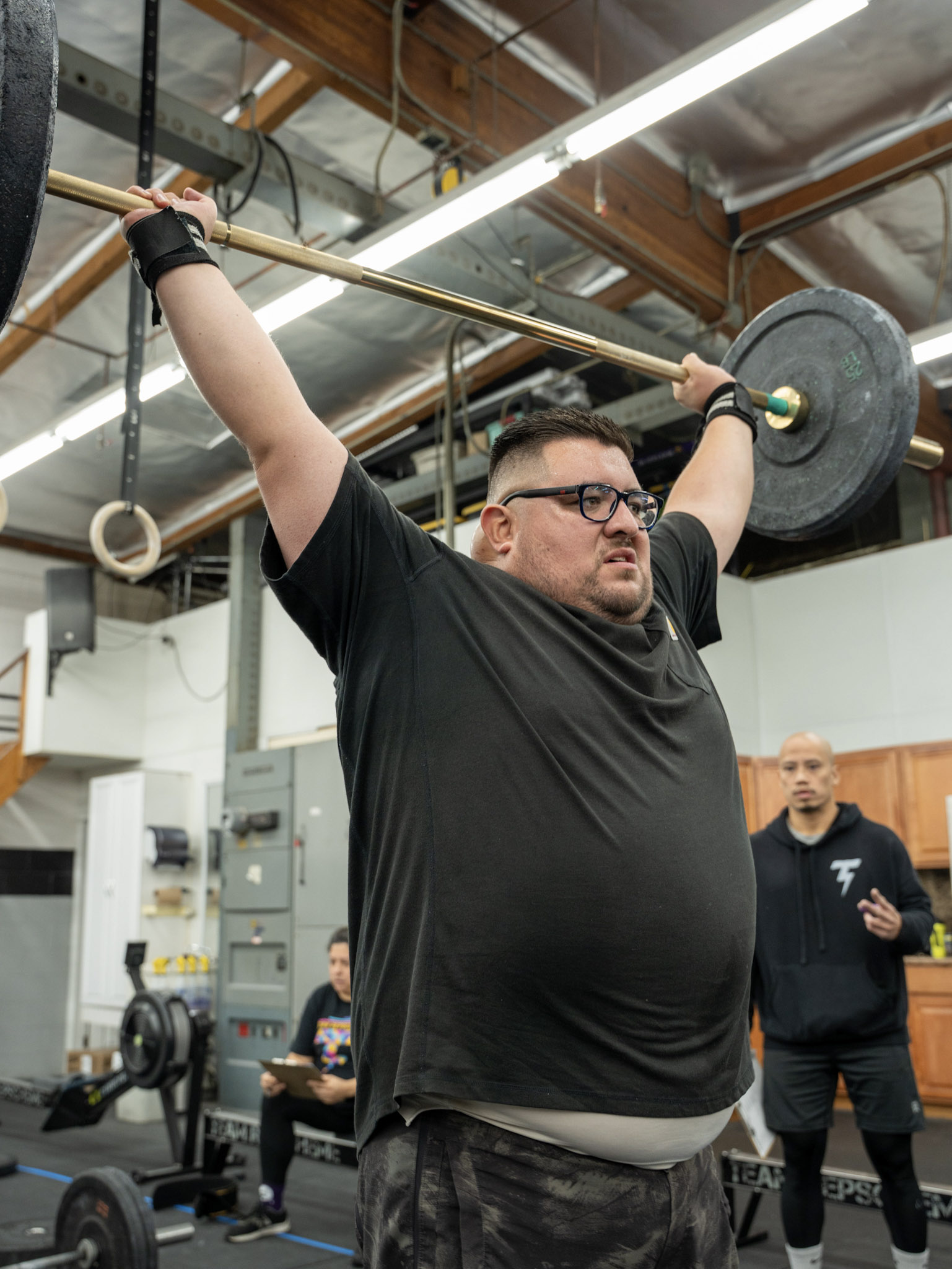 Team RepScheme member completing an overhead barbell lift