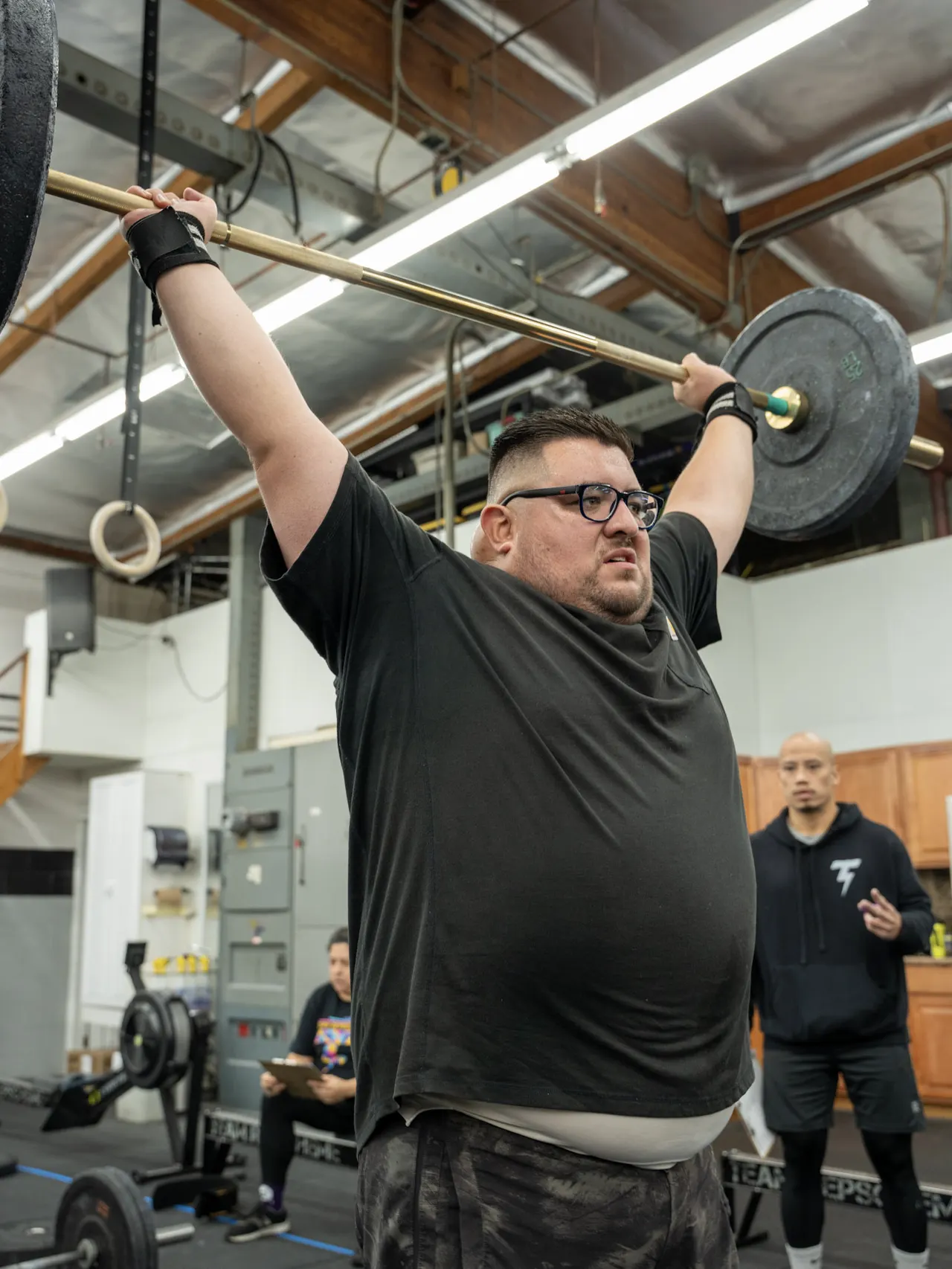 Team RepScheme member completing an overhead barbell lift